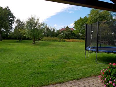 Blick aus dem Freisitz in den Obstgarten, rechts das Trampolin