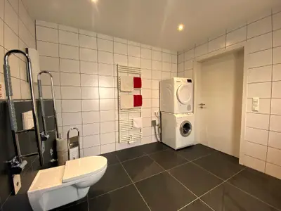 Badezimmer mit Waschmaschine und Trockner.