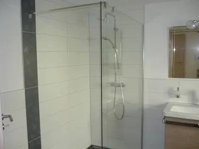 Badezimmer mit ebenerdiger Dusche und Badewanne