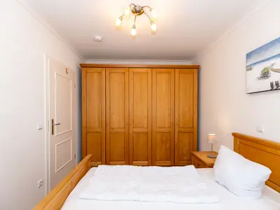 Schlafzimmer mit Doppelbett und Kleiderschrank