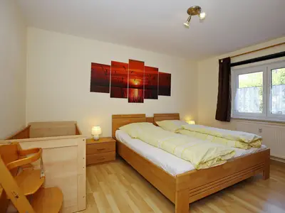 erstes Schlafzimmer mit Kinderhochstuhl, Doppel-und Kinderbett