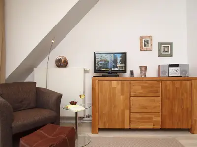 Wohnzimmer mit Sessel und TV