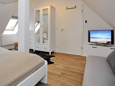 Schlafzimmer mit Kleiderschrank und TV