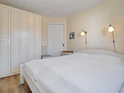 Schlafzimmer mit Doppelbett und Kleiderschrank