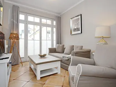 Wohnzimmer mit Schlafcouch und Sessel