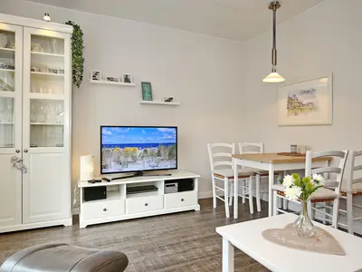 Wohnzimmer mit Esstisch und TV