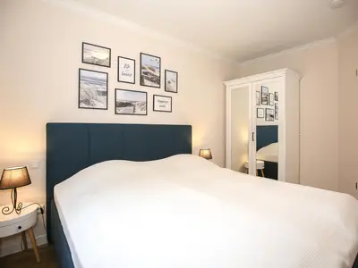 erstes Schlafzimmer mit Doppelbett und Kleiderschrank