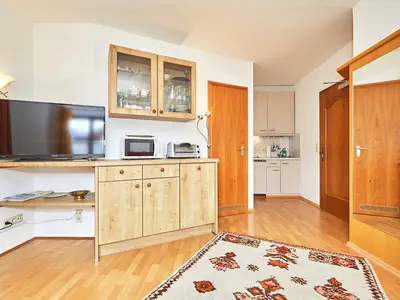 Wohnzimmer mit Küche im Hintergrund