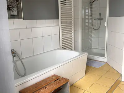 Badezimmer im Obergeschoss mit Toilette, Dusche und einer Badewanne