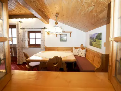 Ausblick aus der Küche durch die Durchreiche in den Essbereich mit Eckbank im Adlernest