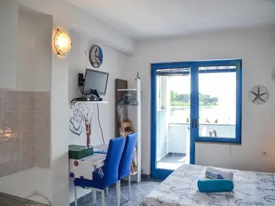 Der Essbereich mit SAT-TV, Ausgang zum Balkon mit Meerblick
