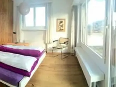 Das Schlafzimmer mit 2 Einzelbetten und direktem Zugang auf die grosse Dachterrasse