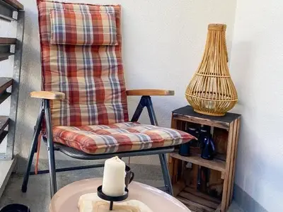 Der Balkon ist ausgestattet mit Balkonstühlen und einem Tischchen.