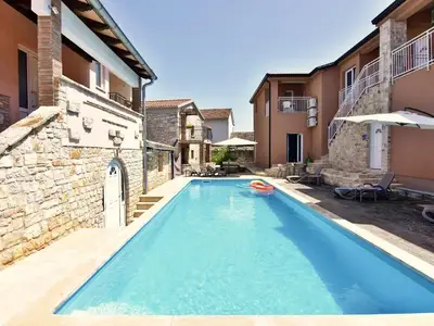 Der Swimmingpool mit Liegestühlen und Sonnenschirmen zur Mitbenutzung.