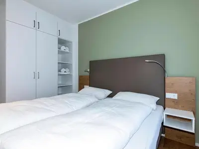 Schlafzimmer mit Doppelbett und Kleiderschrank