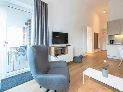 Wohnbereich mit Schlafsofa und TV