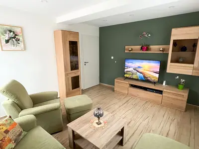 Wohnzimmer mit Couchecke und 50 Zoll Fernseher