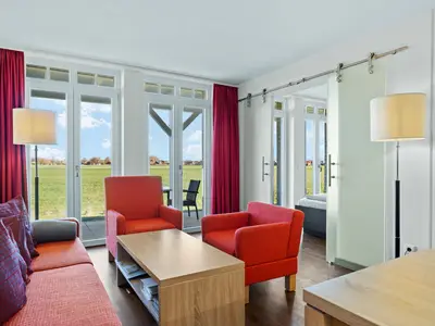 Wohnzimmer mit Couch, Couchtisch und Sessel