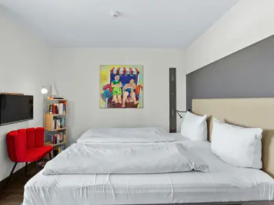 Schlafzimmer mit Doppelbett und TV