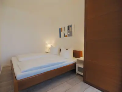 Schlafzimmer mit Doppelbett und großem Kleiderschrank