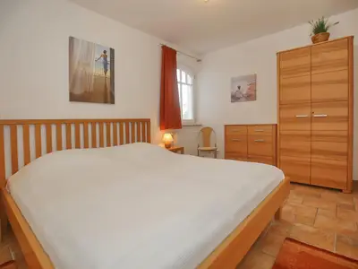 erstes Schlafzimmer mit Doppelbett und Kleiderschrank