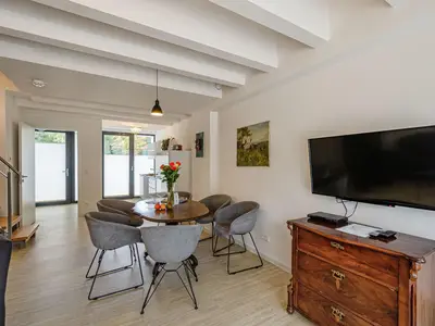 Wohnzimmer: Sofa, TV, Zugang zur Terrasse