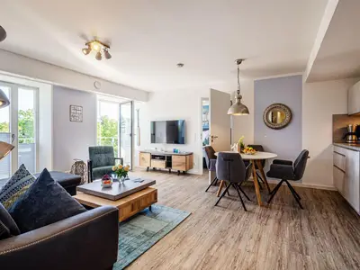 Wohnzimmer: Sofa, TV, Essbereich, Zugang zum Balkon
