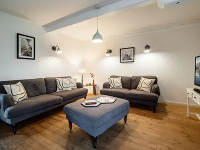 Wohnzimmer mit Kamin, TV und 2 Sofas