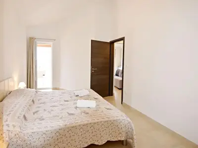 Das Schlafzimmer mit Doppelbett und Ausgang zur Terrasse
