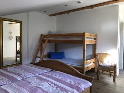 Schlafzimmer mit Doppelbett und Stockbetten
