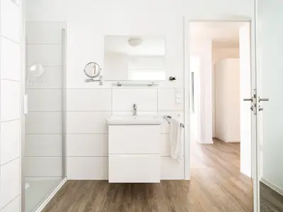 Badezimmer mit Sauna und ebenerdiger Dusche