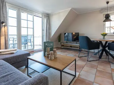 im Wohnzimmer der Ferienwohnung Carmen App. 12 steht ein Sofa mit TV