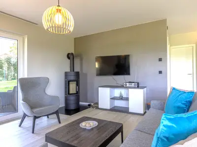 Ferienwohnung Strandflair Ostseebad Wustrow ZweiWasser Alte Seefahrtschule Gemütlicher Wohnbereich mit Kamin