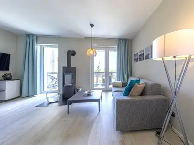 Ferienwohnung Große Strandmuschel Ostseebad Wustrow ZweiWasser Alte Seefahrtschule Wohnbereich mit Kamin