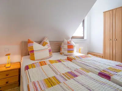 Schlafzimmer mit Doppelbett und Kleiderschrank