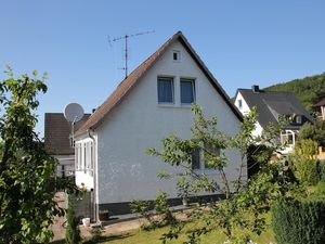 Blick auf den Garten mit den Bergen im Hintergrund