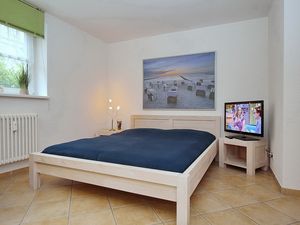 Wohnzimmer mit Doppelbett und TV