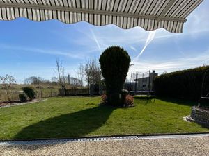 Ausblick von der Terrasse ins Naturschutzgebiet und in den Garten mit eigenem Gartentrampolin