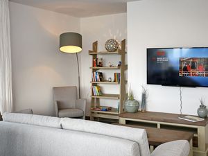 Wohnzimmer mit Schlafcouch und TV