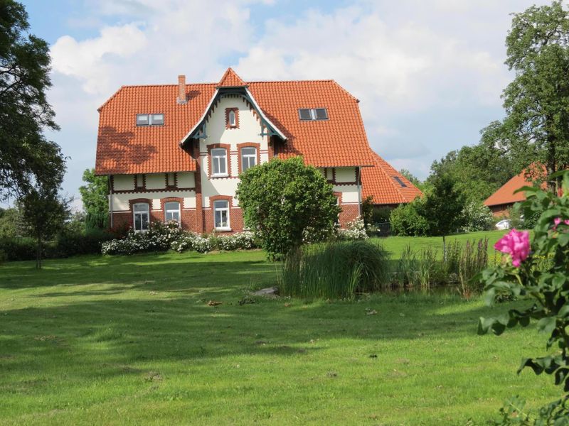 Außenansicht des Gebäudes. Südseite Garten mit Teilbereich des Sees