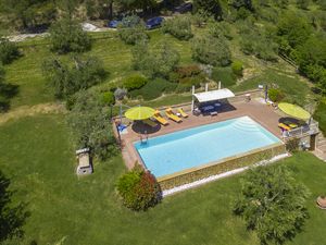 Das Schwimmbad mit dem umgebenden Solarium in der Grünanlage