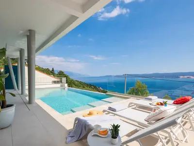 sun deck area (29sqm) with eight deck chairs, a lounge corner, and an outdoor shower