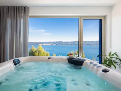 an indoor whirlpool (Hot-Tub), a Finnish sauna, a bathroom with a shower, a TV, and a kitchenette