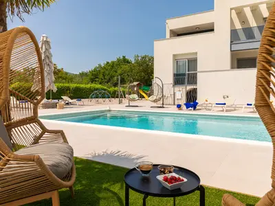 a private and heated, 5m x 10m swimming pool with a spacious sun deck area