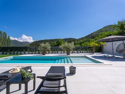 A 40 square meter heated swimming pool and a sun deck with six cozy deck chairs 