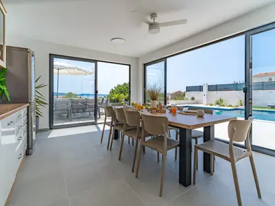 Fully equipped summer kitchen (40sqm) with the outdoor dining area with a ceiling fan, a traditional barbecue