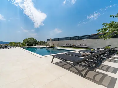 The pool size itself is 11m x 4.25m, plus a hydromassage area with a sitting area 3.5m x 1.2m
