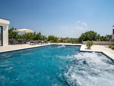 The pool size itself is 11m x 4.25m, plus a hydromassage area with a sitting area 3.5m x 1.2m