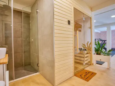 a spa room with Finnis Sauna, Gym with Bluetooth surround system and shower