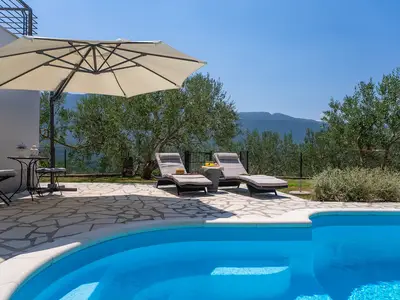 Sun deck area with 4 deck chairs and private pool
